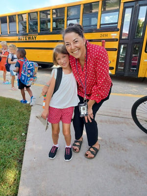 Principal Stuckey and Student posing in front of bus