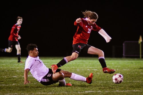 boys soccer student dodging opponent boys soccer student dodging opponent