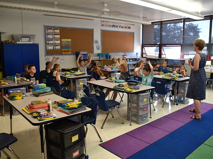 students raising hands